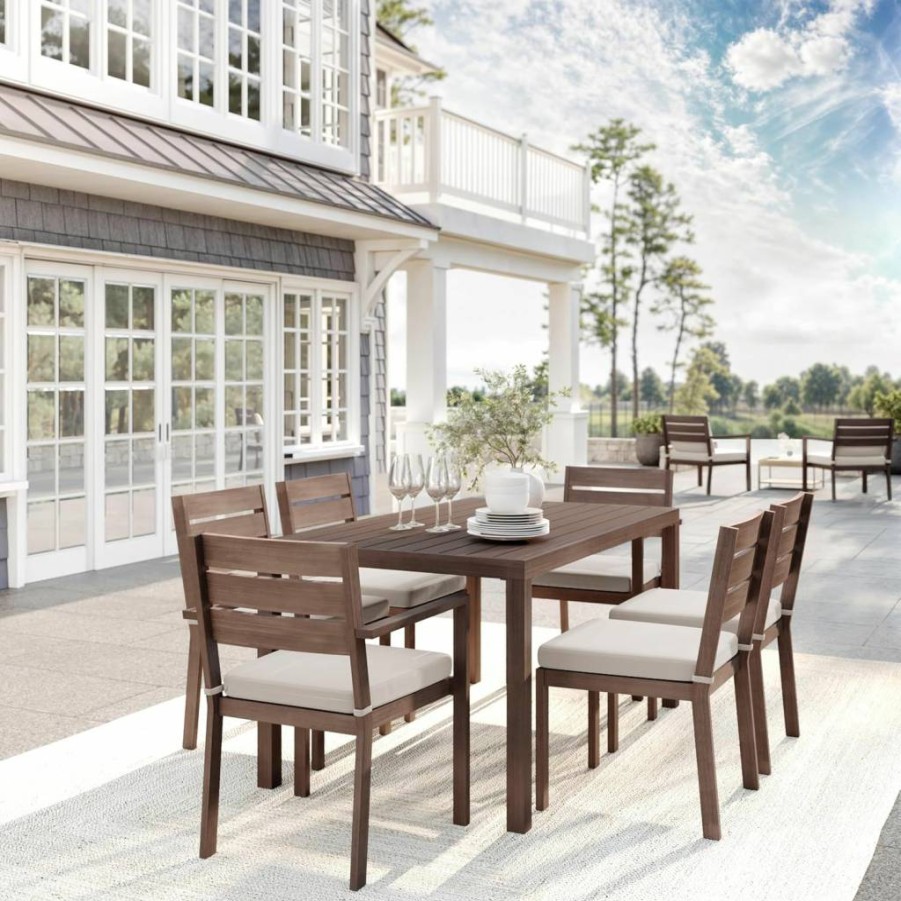 Martha Stewart Bedford 7-Piece Outdoor Dining Set with 62-Inch Woodgrain Aluminum Table, 6 Stackable Chairs, and Cream Weather-Resistant Cushions